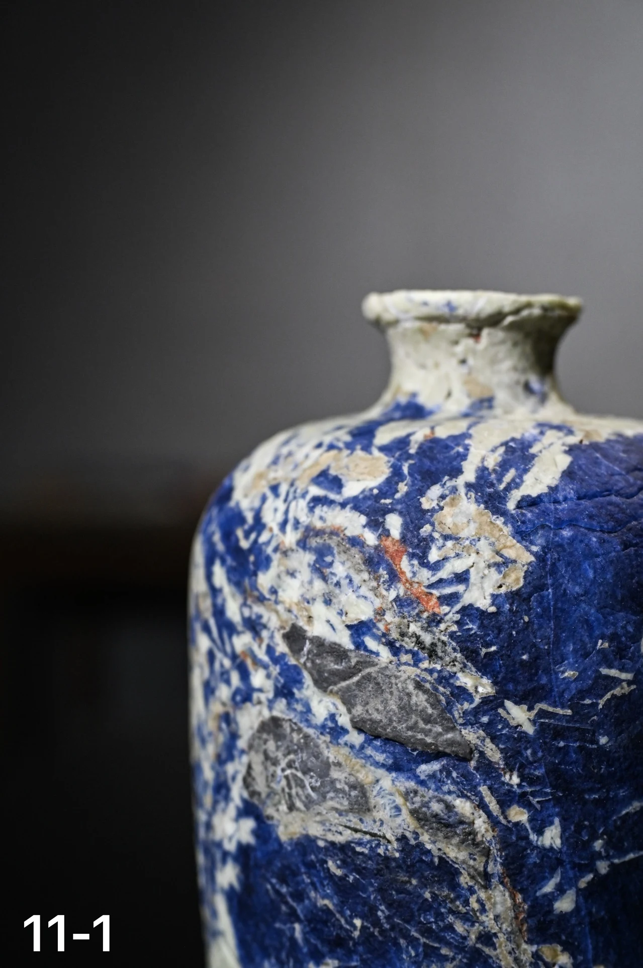 Close-up of blue, ivory and grey stone on a vase
